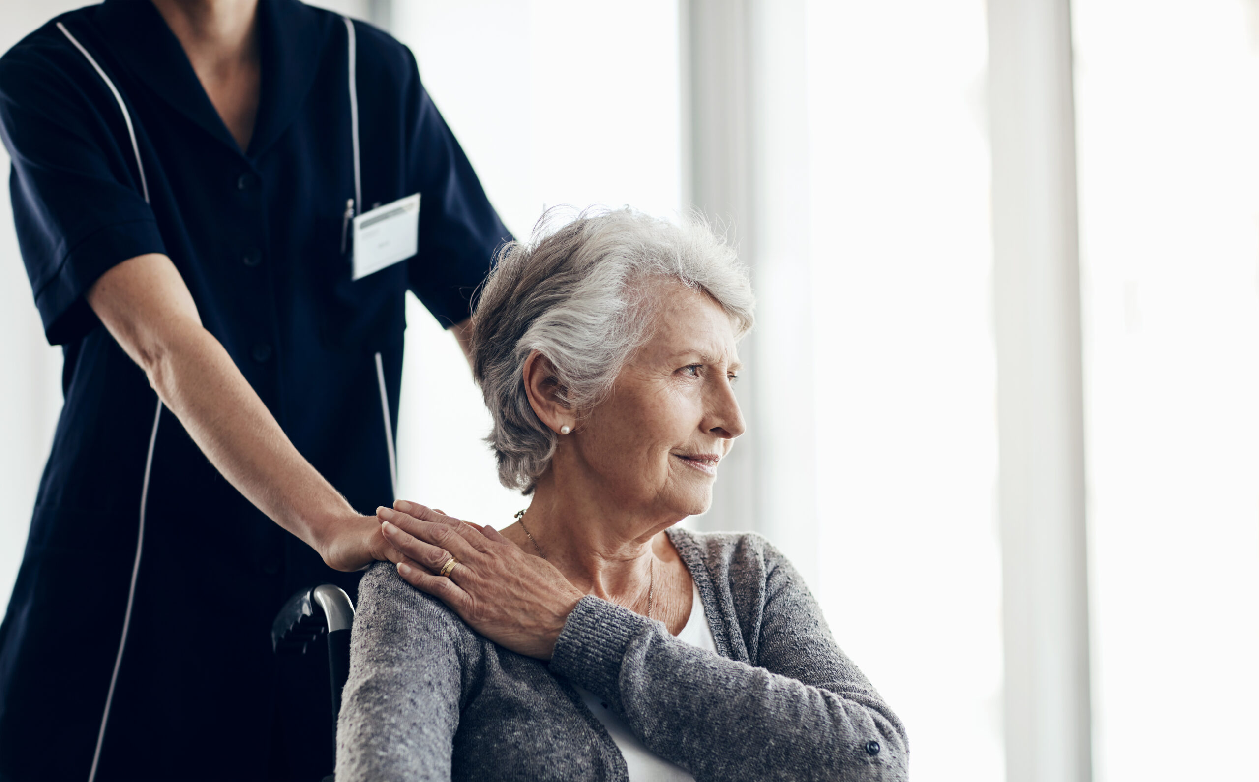 Elder woman in wheelchair cared by nurce